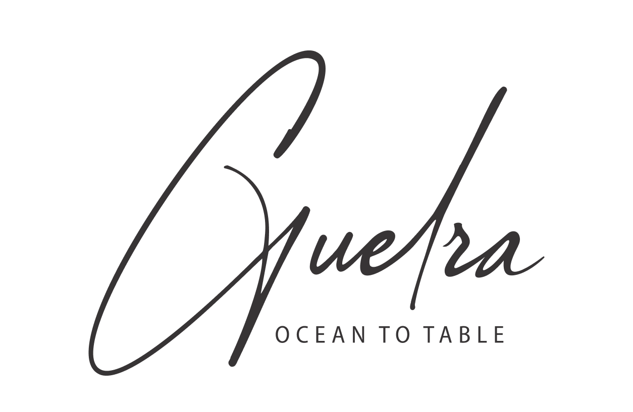 Logotipo com a palavra "Guelra" em fonte cursiva e o texto "Ocean to Table" abaixo.